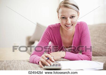 portrait of young woman at home working on personal finance View Large Photo Image Stock Image - portrait of young woman at home working on personal finance. Fotosearch