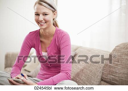 portrait of young woman at home working on personal finance View Large Photo Image Stock Image - portrait of young woman at home working on personal finance. Fotosearch