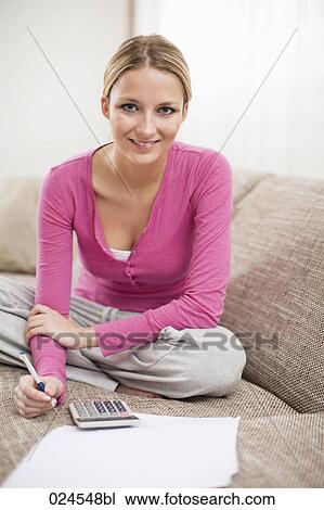 portrait of young woman at home working on personal finance View Large Photo Image Stock Image - portrait of young woman at home working on personal finance. Fotosearch