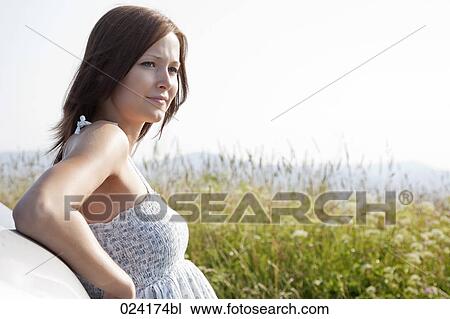 portrait of young woman in summer leaning against car View Large Photo Image Stock Image - portrait of young woman in summer leaning against car. Fotosearch
