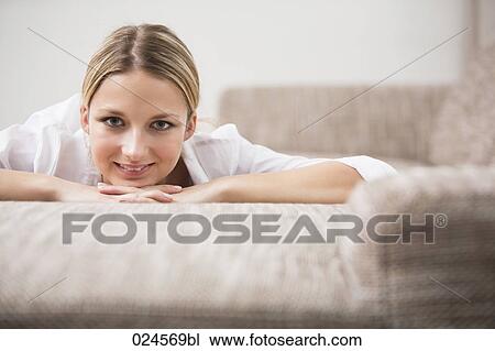 portrait of young woman lying on sofa View Large Photo Image Stock Image - portrait of young woman lying on sofa. Fotosearch