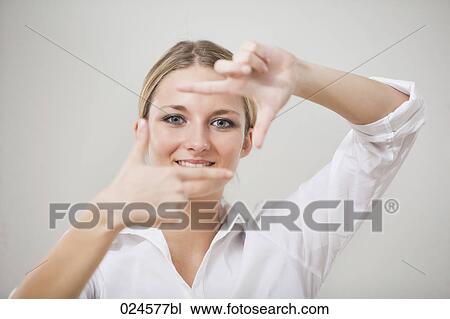 Stock Image - portrait of young woman making framing gesture. Fotosearch