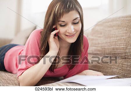 portrait of young woman on sofa talking on mobile phone View Large Photo Image Stock Image - portrait of young woman on sofa talking on mobile phone. Fotosearch