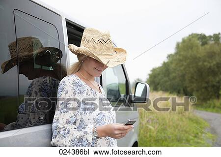 portrait of young woman reading text message on mobile phone View Large Photo Image Stock Image - portrait of young woman reading text message on mobile phone. Fotosearch