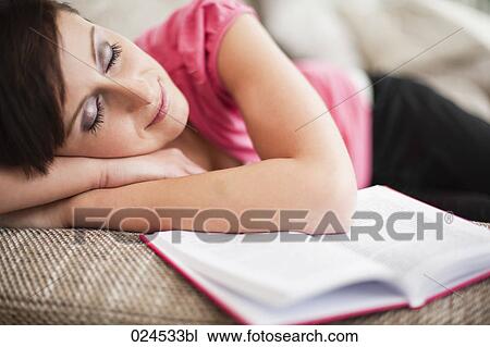 portrait of young woman sleeping on sofa with book View Large Photo Image Stock Image - portrait of young woman sleeping on sofa with book. Fotosearch