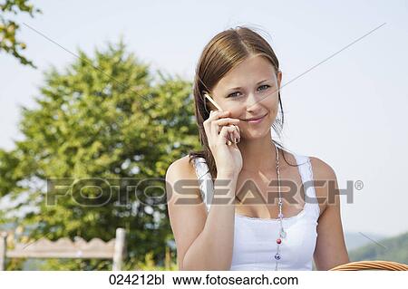 Stock Image - portrait of young woman talking on mobile phone. Fotosearch