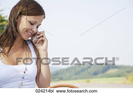 portrait of young woman talking on mobile phone View Large Photo Image Stock Image - portrait of young woman talking on mobile phone. Fotosearch
