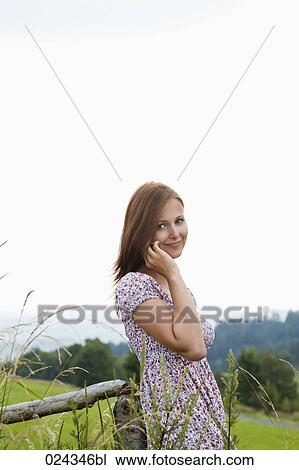 Stock Image - portrait of young woman talking on mobile phone. Fotosearch