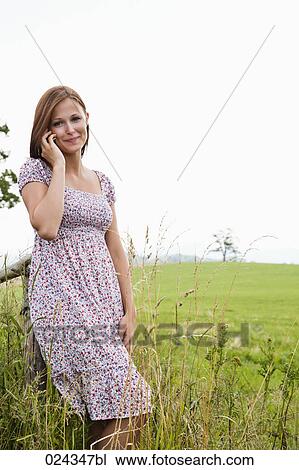 Stock Image - portrait of young woman talking on mobile phone. Fotosearch