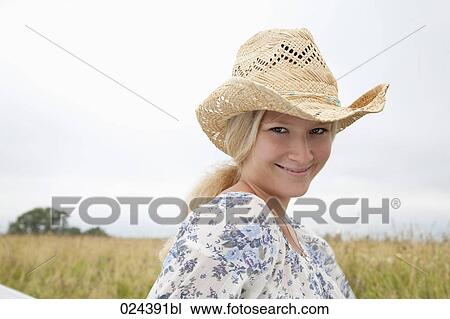 portrait of young woman wearing straw hat View Large Photo Image Stock Image - portrait of young woman wearing straw hat. Fotosearch
