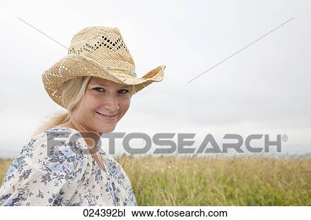 portrait of young woman wearing straw hat View Large Photo Image Stock Image - portrait of young woman wearing straw hat. Fotosearch