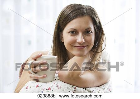 Stock Image - portrait of young woman with cup. Fotosearch