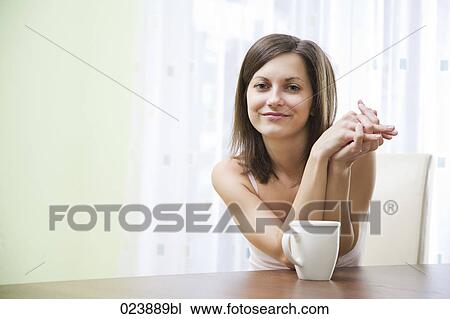 Stock Image - portrait of young woman with cup. Fotosearch