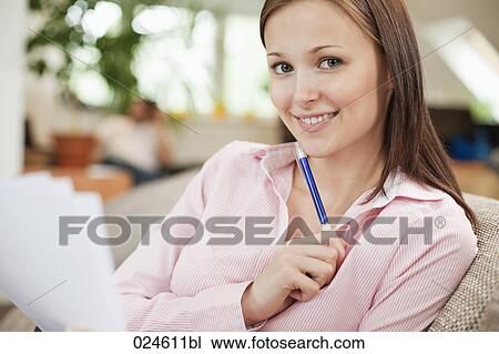 Stock Image - portrait of young woman with document. Fotosearch