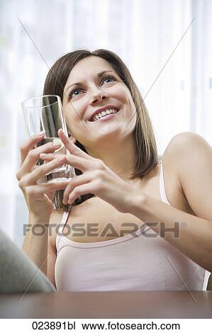 Stock Image - portrait of young woman with glass of water. Fotosearch