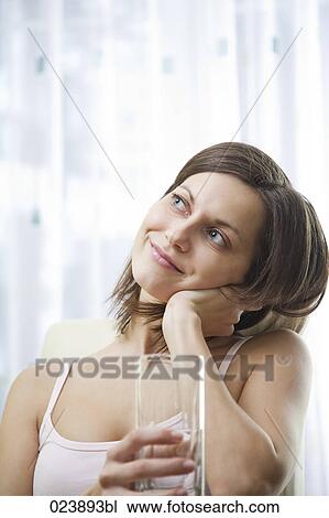 Stock Image - portrait of young woman with glass of water. Fotosearch