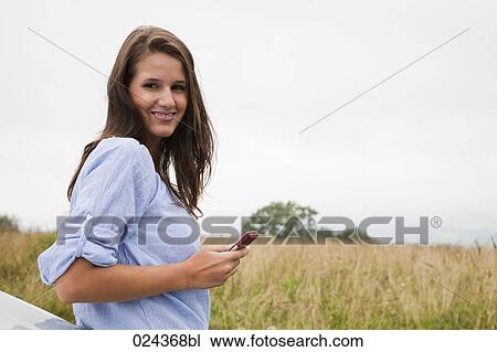 Stock Image - portrait of young woman with mobile phone. Fotosearch