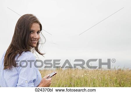 Stock Image - portrait of young woman with mobile phone. Fotosearch
