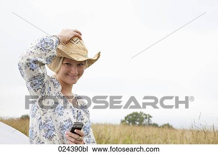 Stock Image - portrait of young woman with mobile phone. Fotosearch