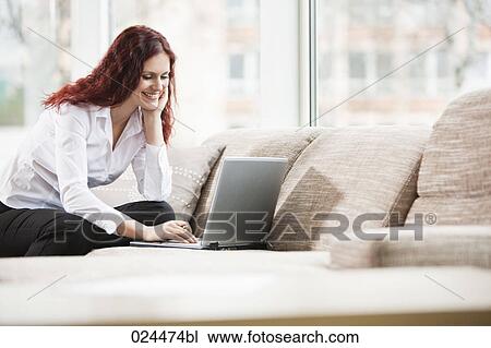 portrait of young woman working with laptop computer at home View Large Photo Image Stock Image - portrait of young woman working with laptop computer at home. Fotosearch