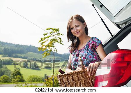 portrait of young young woman with picnic baset at car View Large Photo Image Stock Image - portrait of young young woman with picnic baset at car. Fotosearch