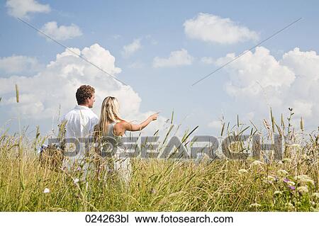 rear view of young couple in field View Large Photo Image Stock Image - rear view of young couple in field. Fotosearch