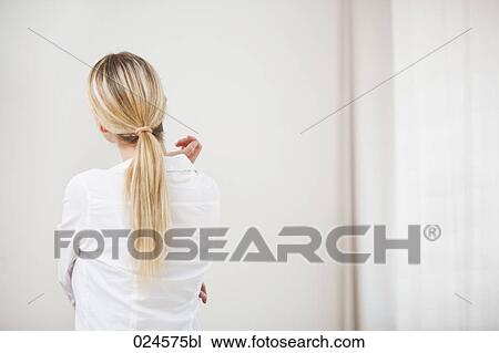 rear view of young woman looking at empty wall View Large Photo Image Stock Image - rear view of young woman looking at empty wall. Fotosearch