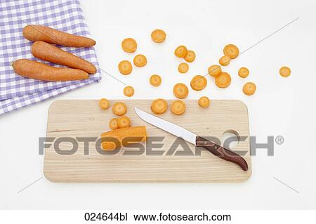 Stock Image - still life of carrots cutting board and knife. Fotosearch