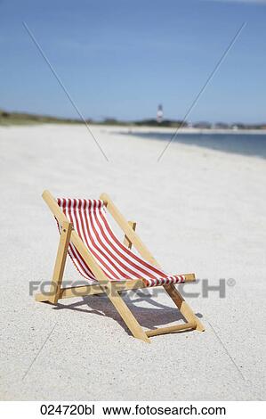 Stock Image - sunlounger on sandy beach. Fotosearch
