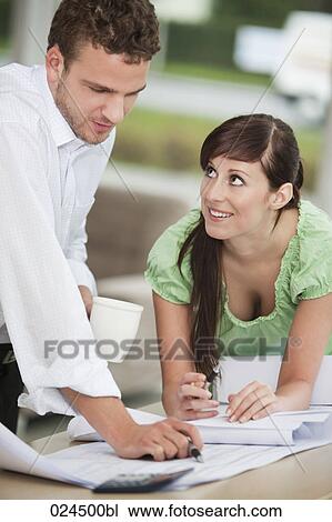 two business people working on blueprint together View Large Photo Image Stock Image - two business people working on blueprint together. Fotosearch