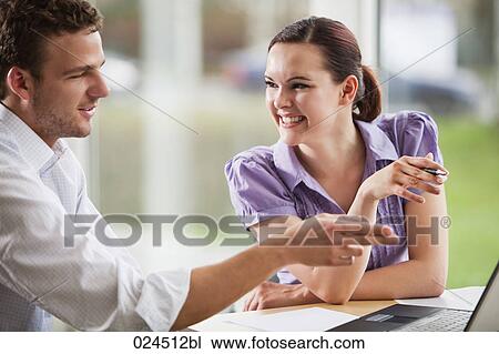 two people talking in front of laptop computer View Large Photo Image Stock Image - two people talking in front of laptop computer. Fotosearch