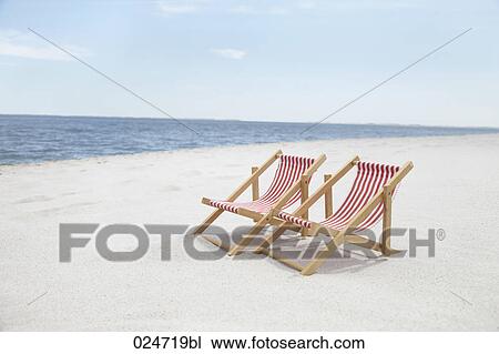 two sunloungers on sandy beach View Large Photo Image Stock Image - two sunloungers on sandy beach. Fotosearch