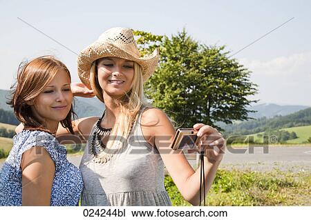 two women taking self-portrait with digital camera View Large Photo Image Stock Image - two women taking self-portrait with digital camera. Fotosearch