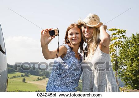 two women taking self-portrait with digital camera View Large Photo Image Stock Image - two women taking self-portrait with digital camera. Fotosearch