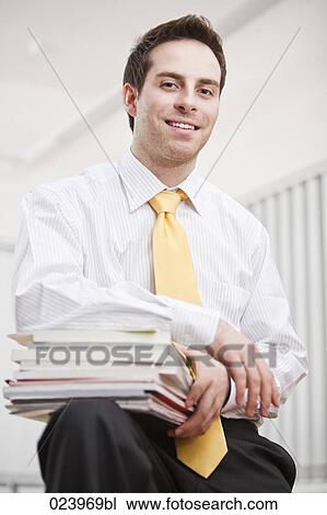 young businessman with pile of documents View Large Photo Image Stock Image - young businessman with pile of documents. Fotosearch