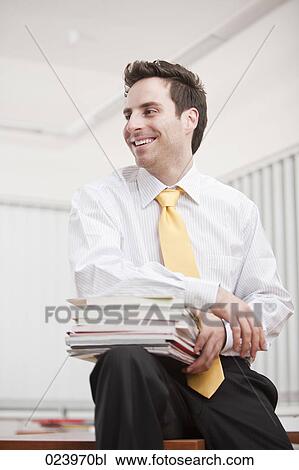 young businessman with pile of documents View Large Photo Image Stock Image - young businessman with pile of documents. Fotosearch