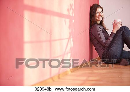 Stock Image - young businesswoman having break drinking coffee. Fotosearch