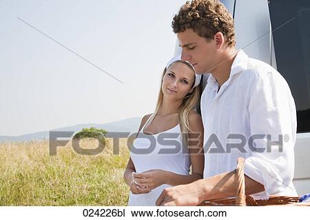 young couple standing at car View Large Photo Image Stock Image - young couple standing at car. Fotosearch
