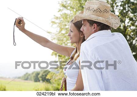 young couple taking picture of themselves View Large Photo Image Stock Image - young couple taking picture of themselves. Fotosearch
