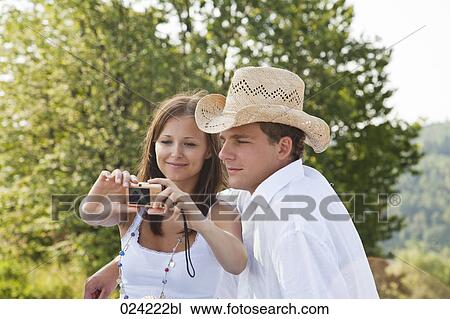 Stock Image - young couple taking picture of themselves. Fotosearch