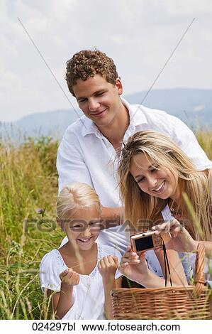 young family taking self-portrait with digital camera in field View Large Photo Image Stock Image - young family taking self-portrait with digital camera in field. Fotosearch