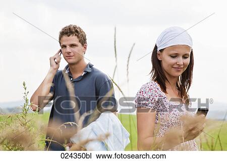 young woman and man with mobile phones View Large Photo Image Stock Image - young woman and man with mobile phones. Fotosearch