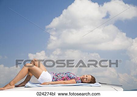 young woman dozing on roof of car View Large Photo Image Stock Image - young woman dozing on roof of car. Fotosearch