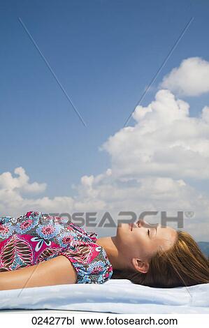 young woman dozing on roof of car View Large Photo Image Stock Image - young woman dozing on roof of car. Fotosearch