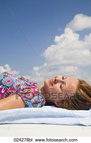 young woman dozing on roof of car View Large Photo Image Stock Image - young woman dozing on roof of car. Fotosearch