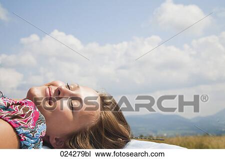 young woman dozing on roof of car View Large Photo Image Stock Image - young woman dozing on roof of car. Fotosearch