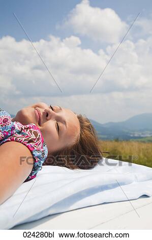 young woman dozing on roof of car View Large Photo Image Stock Image - young woman dozing on roof of car. Fotosearch