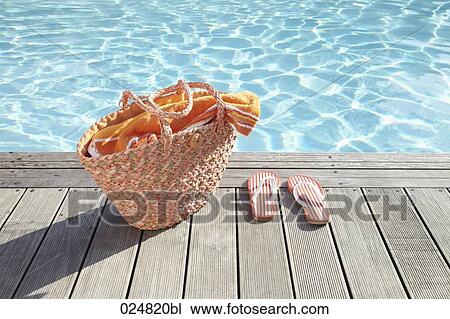 bag with towel and pair of flip flops on planks at swimming pool View Large Photo Image Stock Image - bag with towel and pair of flip flops on planks at swimming pool. Fotosearch