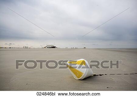 Stock Image - buoy lying on sandy beach. Fotosearch
