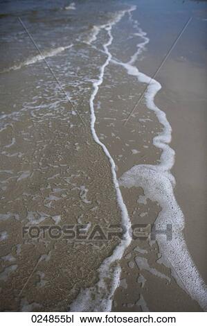 close-up of surf on sandy beach View Large Photo Image Stock Image - close-up of surf on sandy beach. Fotosearch
